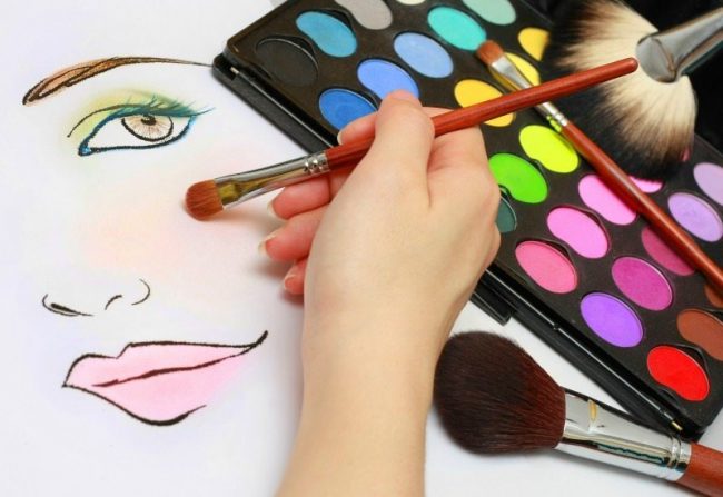 Makeup artist is sketching makeup style on a paper.
