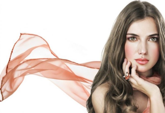 Beautiful woman in salmon color scarf on white