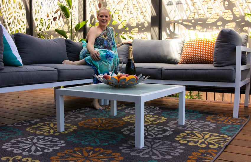 Outdoor living deck renovation Create an outdoor living space with rugs and soft furnishings